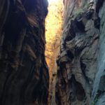 Sun hits high on the cliffs above the Narrows. Zion National Park, Utah